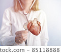 Doctor holding a red heart at hospital office. Medical health care and doctor staff service concept. female cardiologist doctor 85118888
