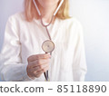 portrait of female doctor listening to heart and breathing, putting stethoscope 85118890
