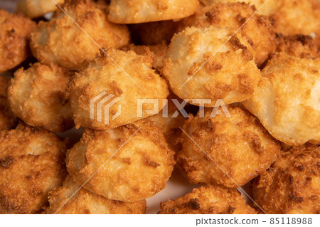 Rocher coco from coconut dessert in brown color make with white eggs and sugar.  85118988