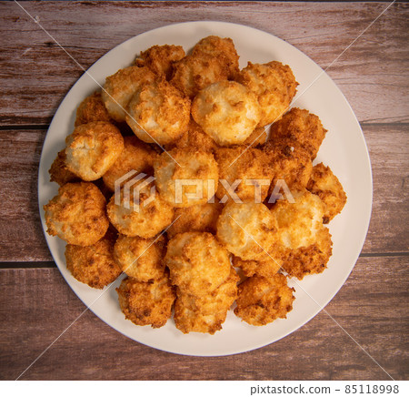 Rocher coco from coconut dessert in brown color make with white eggs and sugar.  85118998