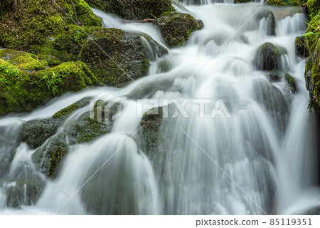 Waterfall on a mountain stream in spring. Vosges, France, Europe. 85119351
