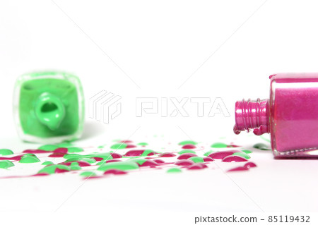 Pink and Green Spilled Nail Polish on White Background 85119432