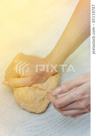 girl makes homemade dough in the kitchen. concept of home cooking. making homemade dough 85119787