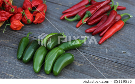 Fresh Peppers outdoors at rural farmers market, Jalapeno, Cayenne and Bhut Jolokia 85119856