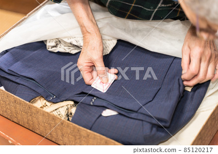 Senior female replacing insect repellent in cosmetic case Senior female replacing insect repellent in cosmetic case 85120217