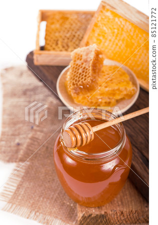 glass pot with floral honey isolated on white background 85121772