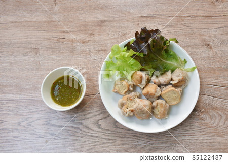 steamed Hakka meatball made from chop pork stuffing fried tofu with fresh vegetable on plate dipping spicy chili sauce steamed Hakka meatball made from chop pork stuffing fried tofu with fresh vegetable on plate dipping spicy chili sauce 85122487