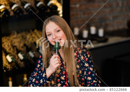 Amazed funny kid lick candy lollipop during winter holidays 85122666