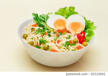 Noodle Dish with Green Pea, Carrot, Eggs, Red Hot Pepper and Greens Noodle Dish with Green Pea, Carrot, Eggs, Red Hot Pepper and Greens 85124091