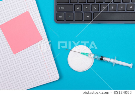 Vaccination or Revaccination Concept - A Medical Syringe on Blue Table 85124093