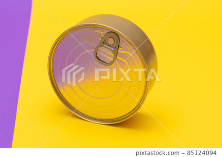 Unopened Tin Can with Blank Edge on Split Yellow and Violet Background Unopened Tin Can with Blank Edge on Split Yellow and Violet Background 85124094