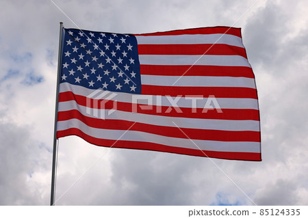 US American flag waving in stormy cloudy sky US American flag waving in stormy cloudy sky 85124335
