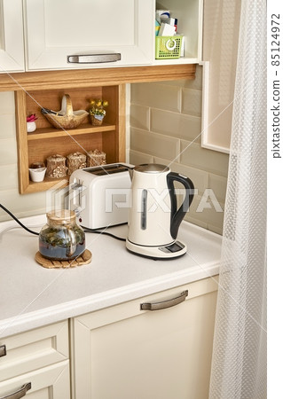 Teapot near hot drink electric kettle and toaster in kitchen 85124972