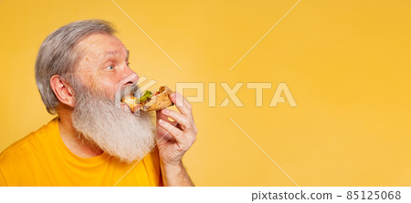 Flyer. Close-up senior bearded man enjoying taste of pizza isolated on yellow studio background. World pizza day Flyer. Close-up senior bearded man enjoying taste of pizza isolated on yellow studio background. World pizza day 85125068