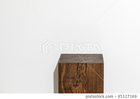 Solid oak wood stump against white wall. Wood coffee table 85127169