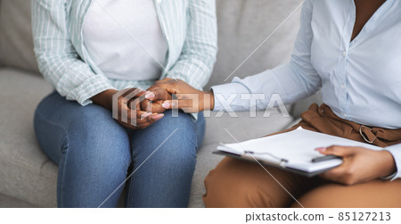 Therapist providing psychological assistance to female patient, holding her hand at clinic, cropped view. Banner design Therapist providing psychological assistance to female patient, holding her hand at clinic, cropped view. Banner design 85127213