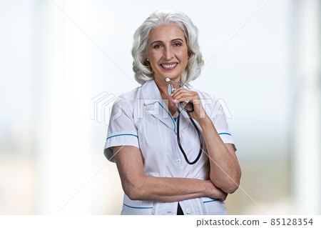 Happy smiling woman doctor holding stethoscope and looking at camera. 85128354