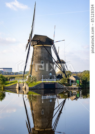 Vertical picture of one of the famous Dutch windmills at Kinderdijk, a UNESCO world heritage site Vertical picture of one of the famous Dutch windmills at Kinderdijk, a UNESCO world heritage site 85128384