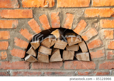 firewood in a red brick oven 85128966