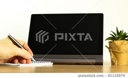 Education and business concept. Tablet with empty screen for your text. Male hand with pen, hous plant. Copy space. 85128974