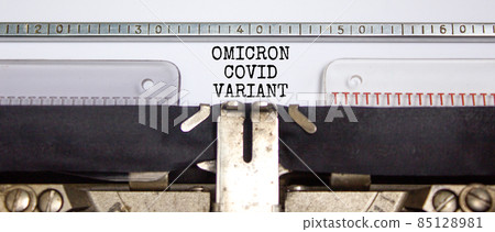 Covid-19 new omicron virus variant symbol. Concept words Omicron covid variant typed on retro typewriter. Medical and COVID-19 pandemic new omicron variant strain mutation concept. 85128981