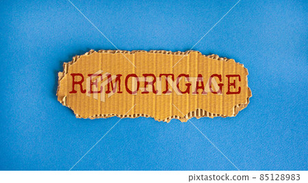 Remortgage symbol. The concept word 'remortgage' on the piece of cardboard. Beautiful blue background, copy space. Business and remortgage concept. Remortgage symbol. The concept word 'remortgage' on the piece of cardboard. Beautiful blue background, copy space. Business and remortgage concept. 85128983