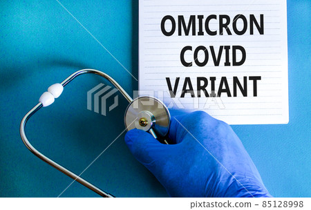 New covid-19 omicron variant strain symbol. Hand in blue glove with white note. Concept words Omicron covid variant. Stethoscope. Medical and COVID-19 omicron variant strain concept. Copy space. New covid-19 omicron variant strain symbol. Hand in blue glove with white note. Concept words Omicron covid variant. Stethoscope. Medical and COVID-19 omicron variant strain concept. Copy space. 85128998