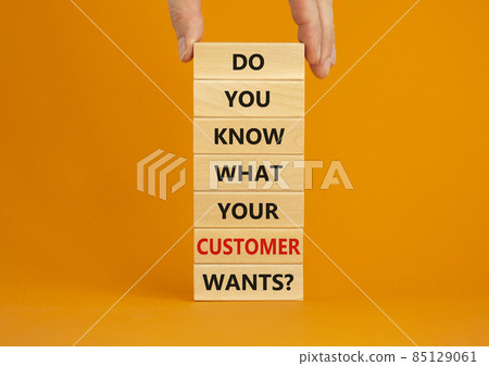 Support your client symbol. Concept words Do you know what your customer wants on wooden blocks on a beautiful orange background, copy space. Businessman hand. Business, support your client concept. 85129061