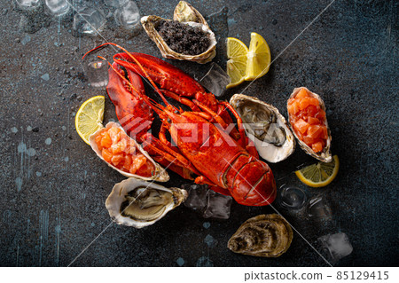 Seafood assorted with lobster, oysters, salmon tartare, black caviar top view Seafood assorted with lobster, oysters, salmon tartare, black caviar top view 85129415