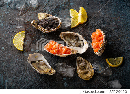 Seafood assorted starters and appetizers salmon tartare, black caviar, oysters Seafood assorted starters and appetizers salmon tartare, black caviar, oysters 85129420