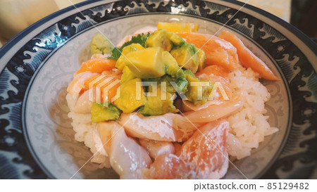Close up images of japanese seafood rice bowl or kaisendon sashimi donburi or KAISEN CHIRASHI DON which have raw fresh ogura uni shrimp crab and fish on rice bowl. wood table from top view angle. Close up images of japanese seafood rice bowl or kaisendon sashimi donburi or KAISEN CHIRASHI DON which have raw fresh ogura uni shrimp crab and fish on rice bowl. wood table from top view angle. 85129482