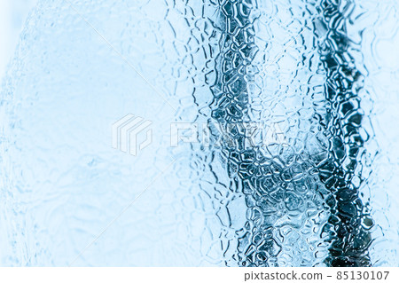 Abstract ice texture. Frozen crystals and icicles on a white background. Strong frost in winter. 85130107
