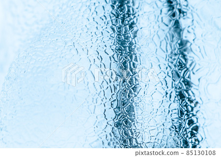 Abstract ice texture. Frozen crystals and icicles on a white background. Strong frost in winter. 85130108