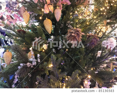 Festive Christmas border, isolated on white background. Fir green branches are decorated with red stars, berries, fir cones and red toy deer, close-up Festive Christmas border, isolated on white background. Fir green branches are decorated with red stars, berries, fir cones and red toy deer, close-up 85130383