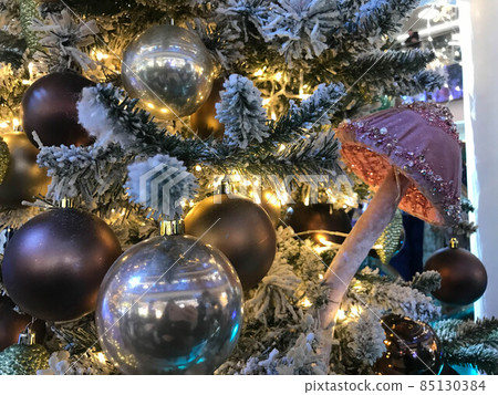 Christmas tree decorated with Golden and blue balls toys on a blurred, sparkling and fabulous fairy background with beautiful bokeh, copy spacet Christmas tree decorated with Golden and blue balls toys on a blurred, sparkling and fabulous fairy background with beautiful bokeh, copy spacet 85130384