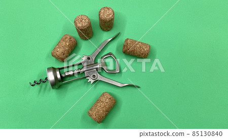 Steel wine corkscrew together with wooden corks lie on the chromakey table Steel wine corkscrew together with wooden corks lie on the chromakey table 85130840