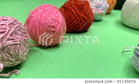 Multi-colored threads for knitting lie on the chromakey table Multi-colored threads for knitting lie on the chromakey table 85130850