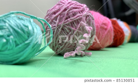 Multi-colored threads for knitting lie on the chromakey table Multi-colored threads for knitting lie on the chromakey table 85130851