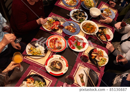 Meeting friends at the festive table. 85130887