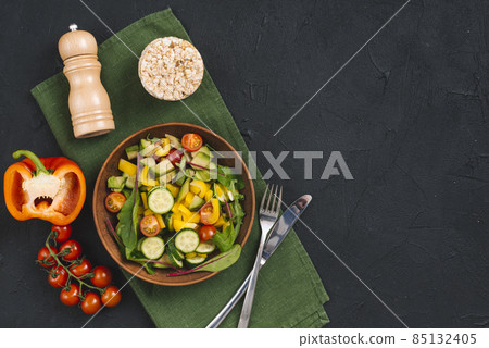 rice puffed cake vegetables salad pepper shakers napkin black concrete textured backdrop. High quality photo rice puffed cake vegetables salad pepper shakers napkin black concrete textured backdrop. High quality photo 85132405