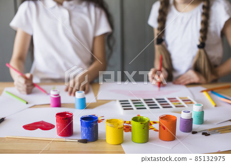 colorful paint colors front girl painting white paper table. High quality photo 85132975