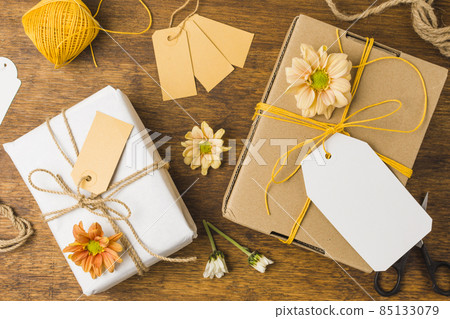 wrapped gift tied with tag string beautiful flower wooden surface. High quality photo wrapped gift tied with tag string beautiful flower wooden surface. High quality photo 85133079