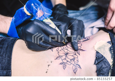 hands making tattoo with machine. High quality photo hands making tattoo with machine. High quality photo 85133257