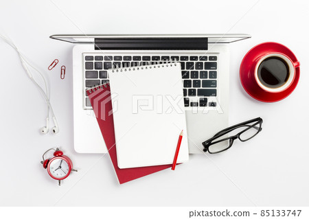 overhead view office supplies laptop coffee cup alarm clock spectacles white desk. High quality photo overhead view office supplies laptop coffee cup alarm clock spectacles white desk. High quality photo 85133747