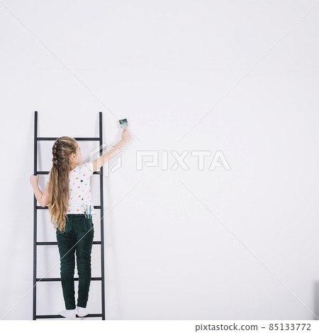 little girl ladder painting wall. High quality photo little girl ladder painting wall. High quality photo 85133772