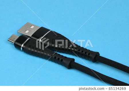 Closeup of an USB connector isolated on blue. Closeup of an USB connector isolated on blue. 85134269