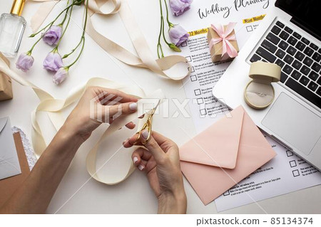 feminine hands creating handmade invitations. High quality photo feminine hands creating handmade invitations. High quality photo 85134374
