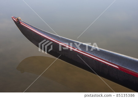 bow of a racing kayak on calm lake 85135386