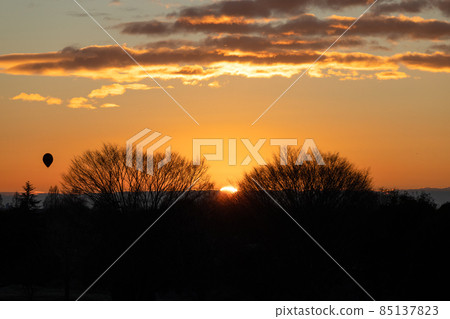 Hot-air balloon flying in the sunrise Hot-air balloon flying in the sunrise 85137823