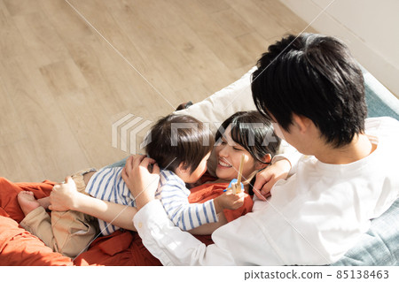 A close family relaxing on the sofa A close family relaxing on the sofa 85138463